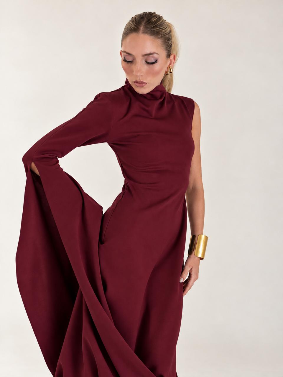 Detail of the draped neckline and open sleeve on the burgundy dress