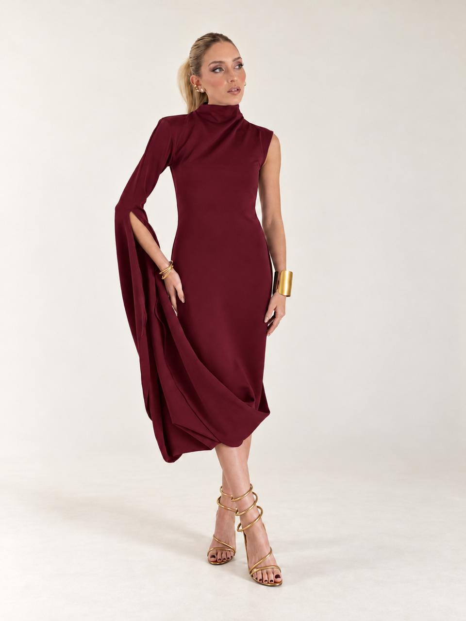 Model wearing a burgundy asymmetric dress, full-length view
